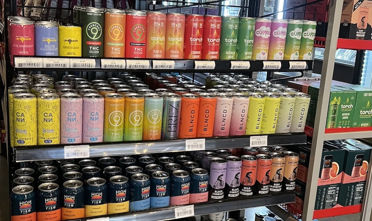 A retail cooler stocked with hemp-derived THC seltzers from brands including Crescent 9, Cann, BLNCD, High Rise, and Torch