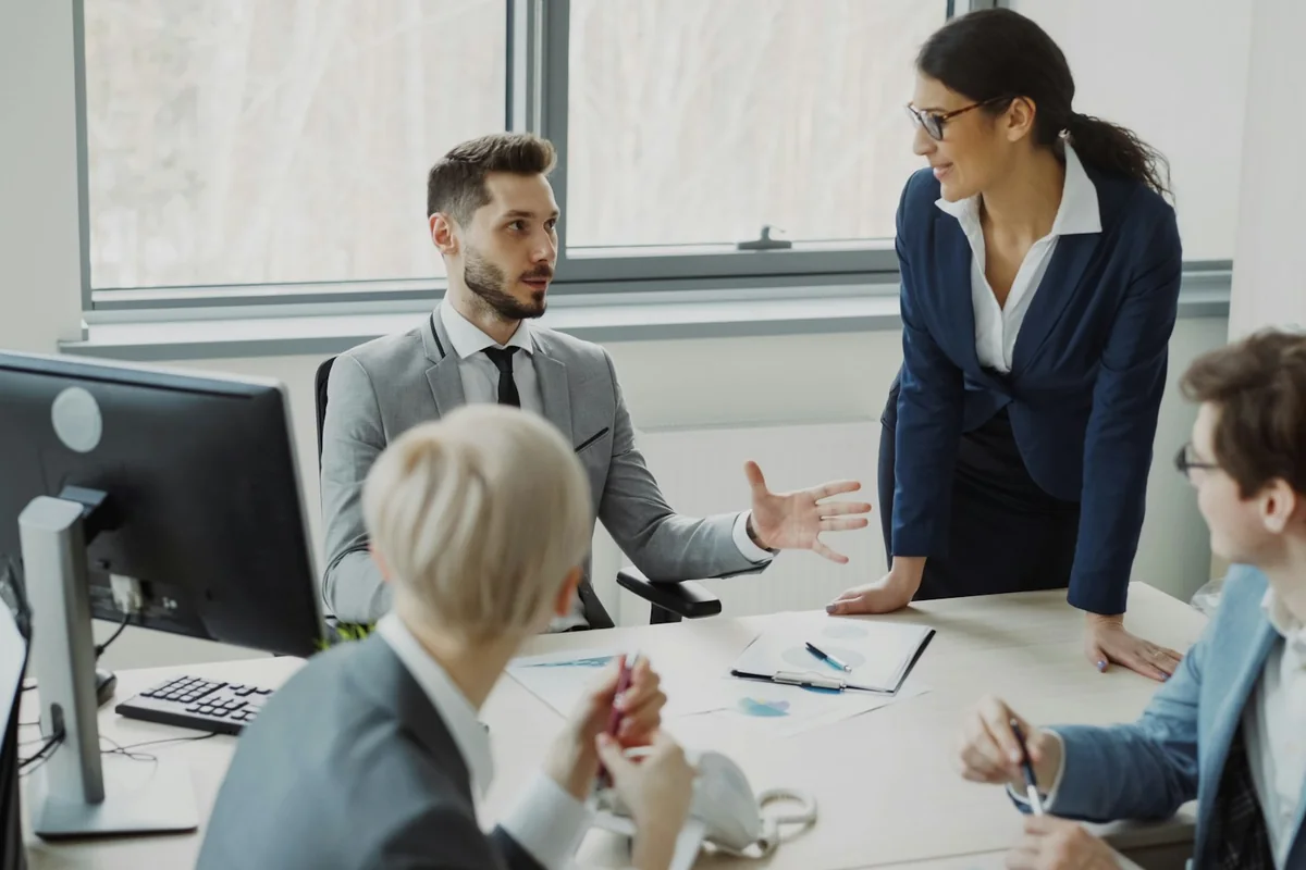 Coworkers collaborating around a table in a modern office