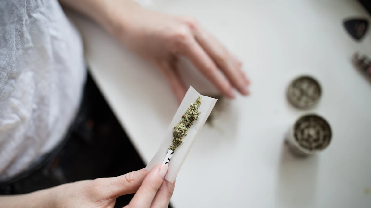 A cannabis pre-roll photographed in a neutral setting