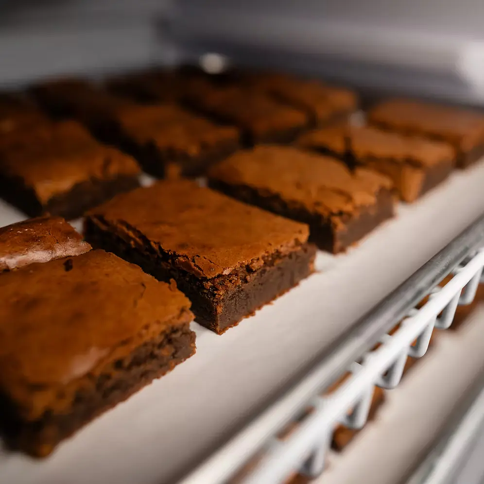 Freshly baked fudgy chocolate brownies cooling on a rack