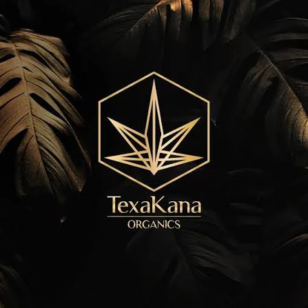 TexaKana Organics gold logo against dark tropical leaves